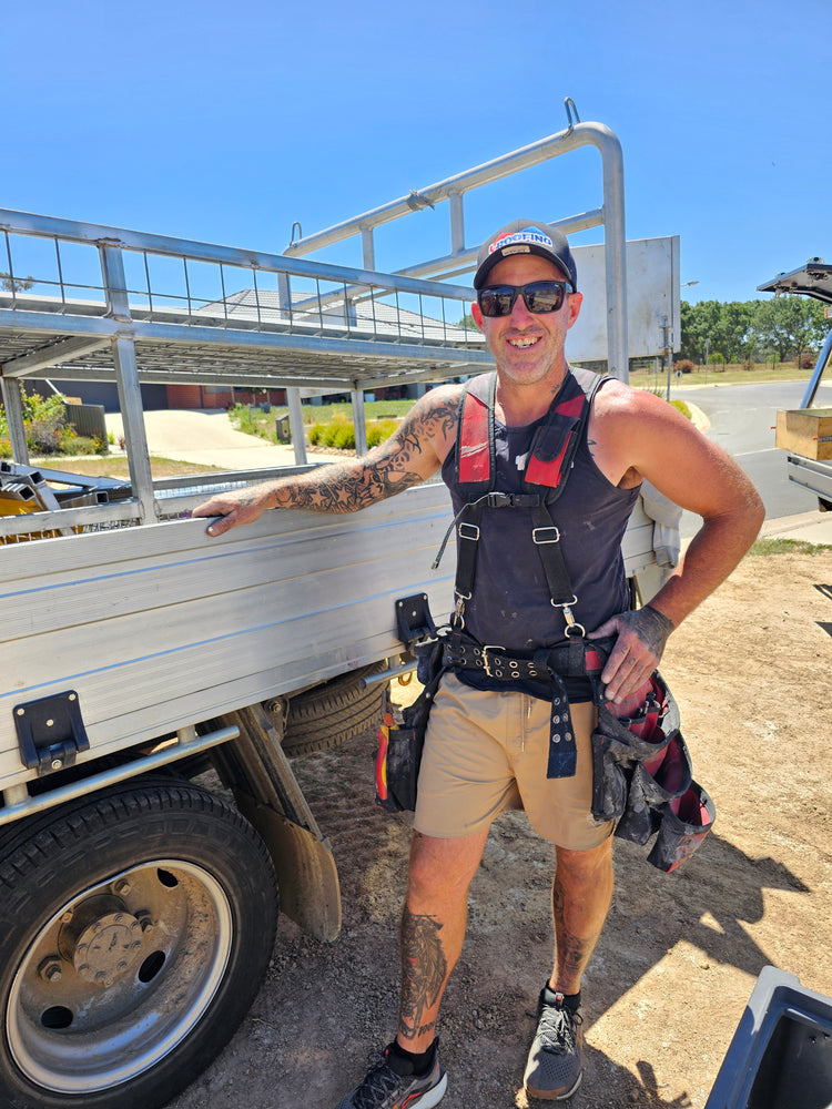 LK Roofing crew member in harness beside the ute